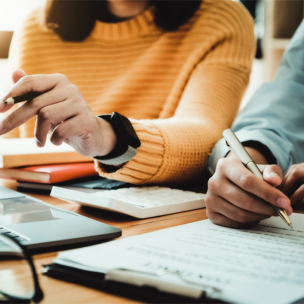 close up of someone signing a loan agreement