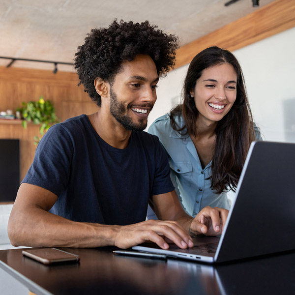 couple working on laptop at home